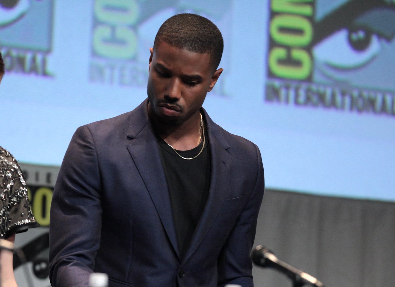 Michael B. Jordan wearing a navy blue suit