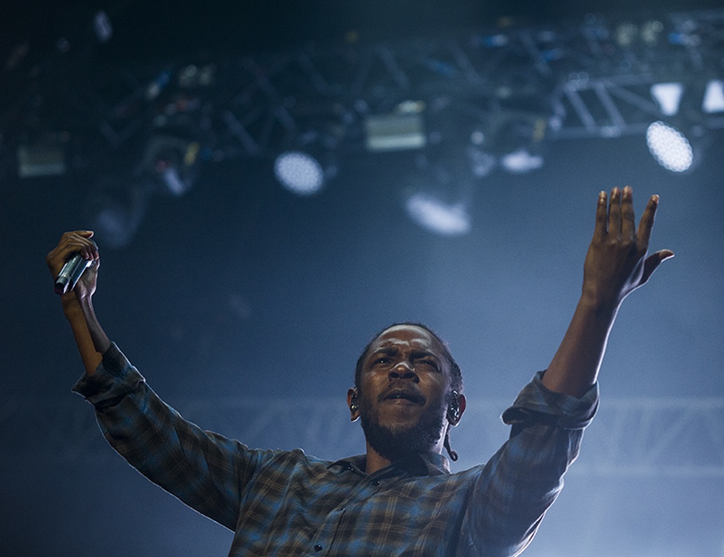 Kendrick Lamar performing on stage.