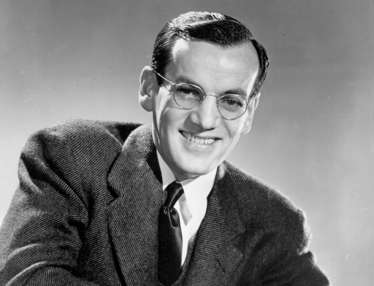Photo of Glenn Miller wearing glasses and suit
