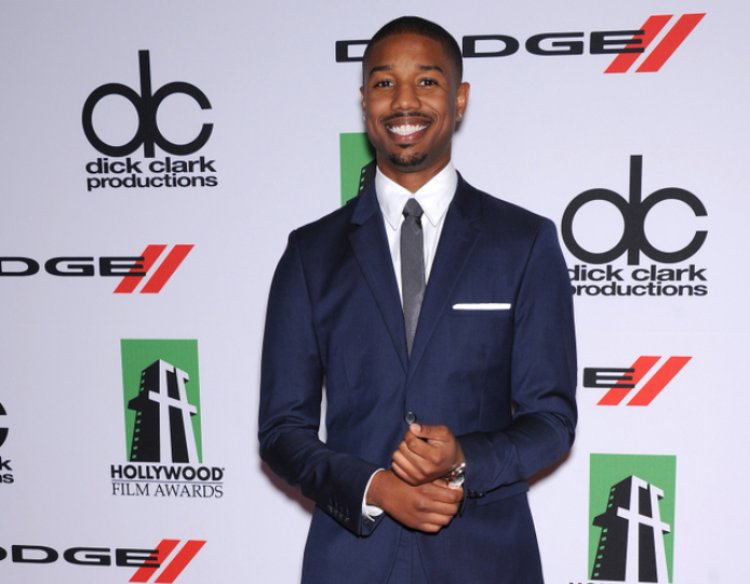 Michael B. Jordan wearing a navy blue suit