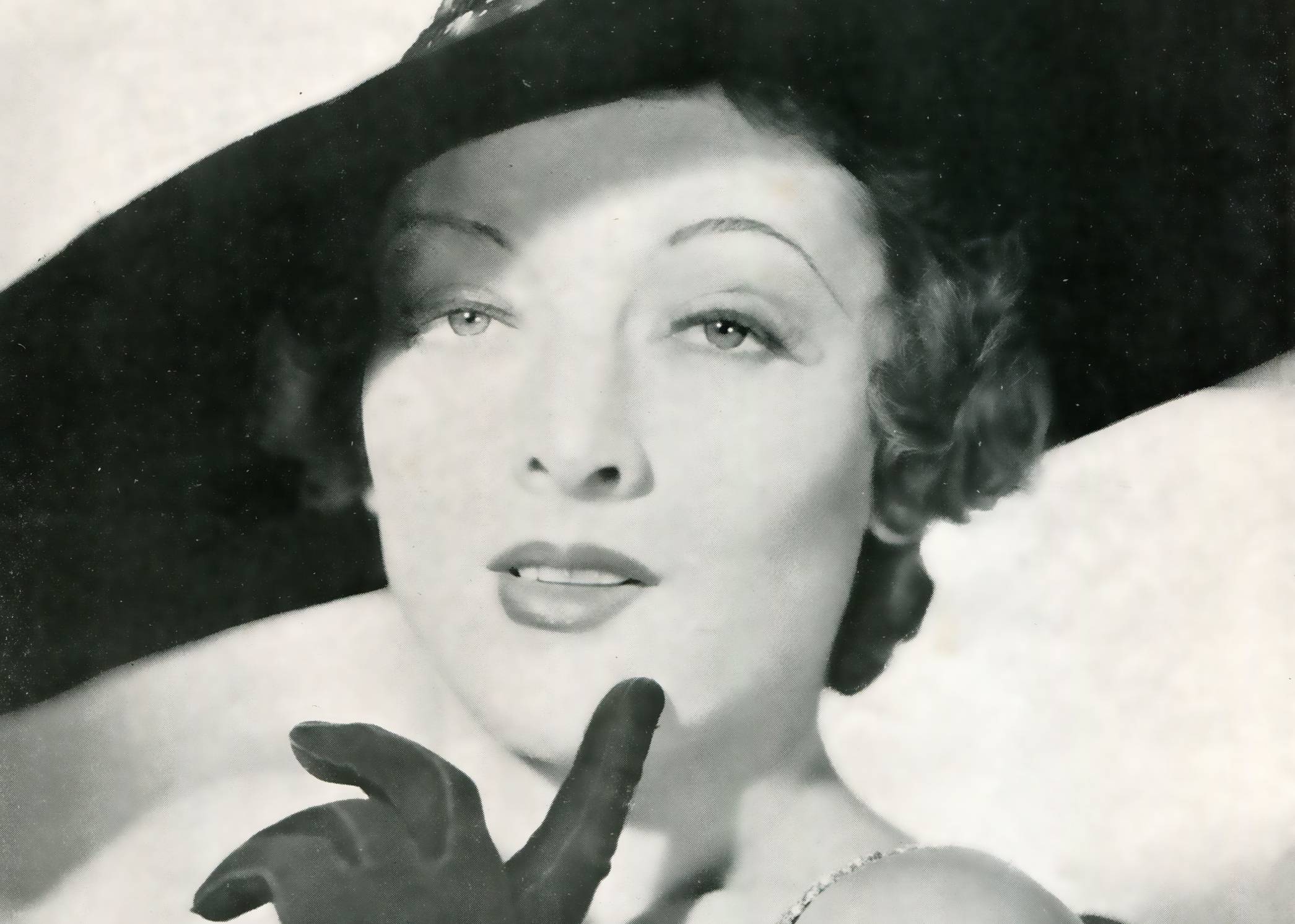 Mirna Loy in black dress and a hat