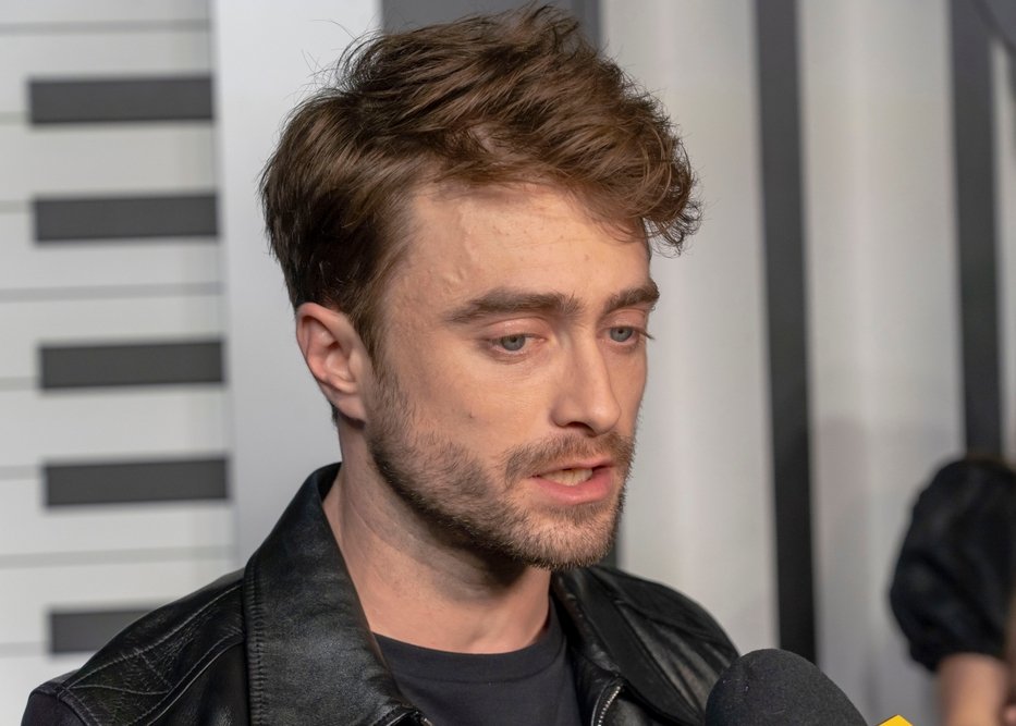 Daniel Radcliffe wearing a black leather jacket