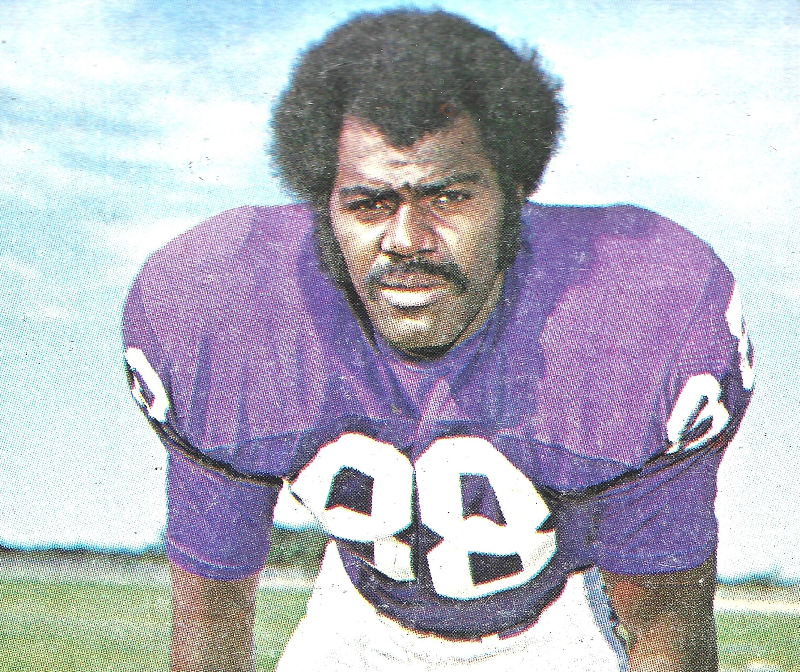 1975 Alan Page posing with a jersey