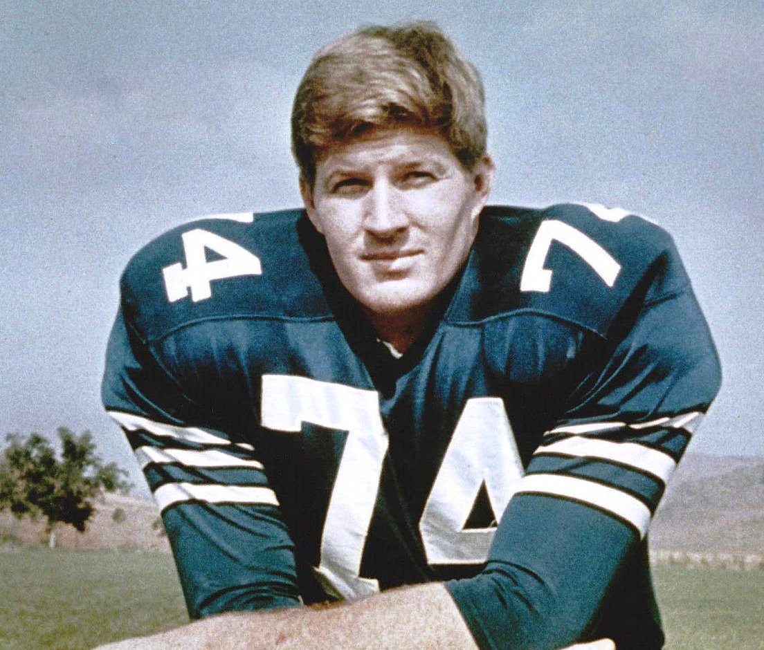 Bob Lilly posing with a jersey