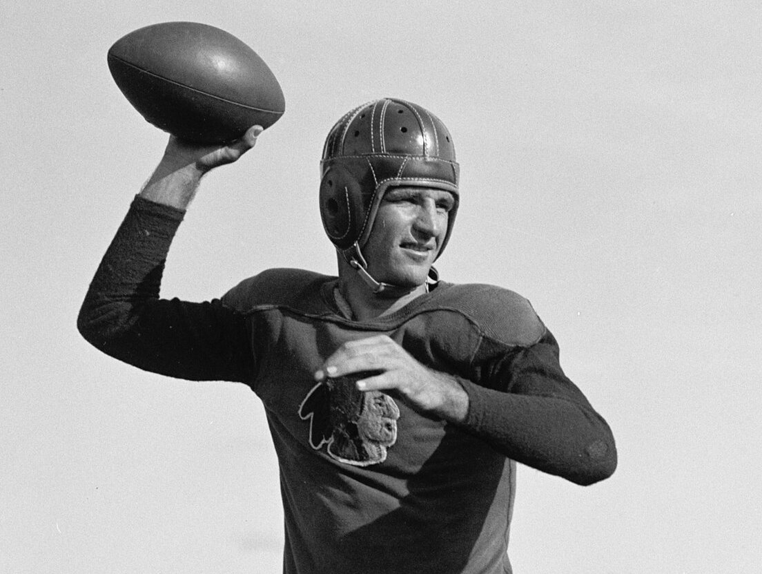 Slingin Sammy Baugh, posing with a rugby ball 