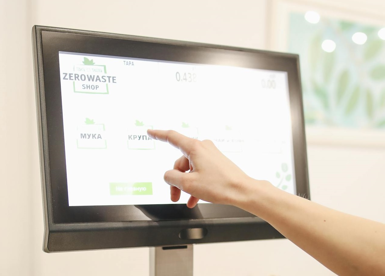 Person Pointing at Black Flat Screen Display.