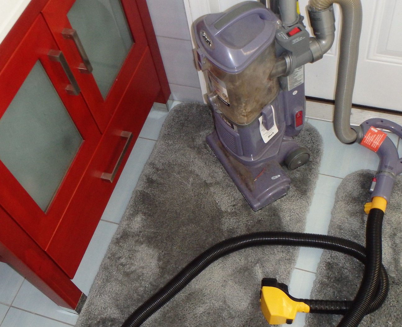 Flowbee Vacuum Hair Cutting System placed on a floor