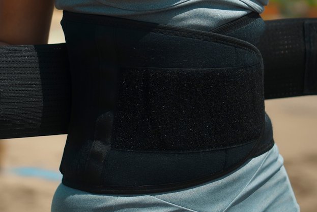 Girl stands on the beach in the belt for weight loss