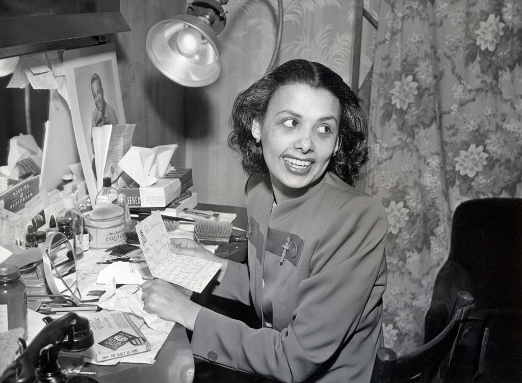 Lena Horne, noted black singer and entertainer, reads a personal note