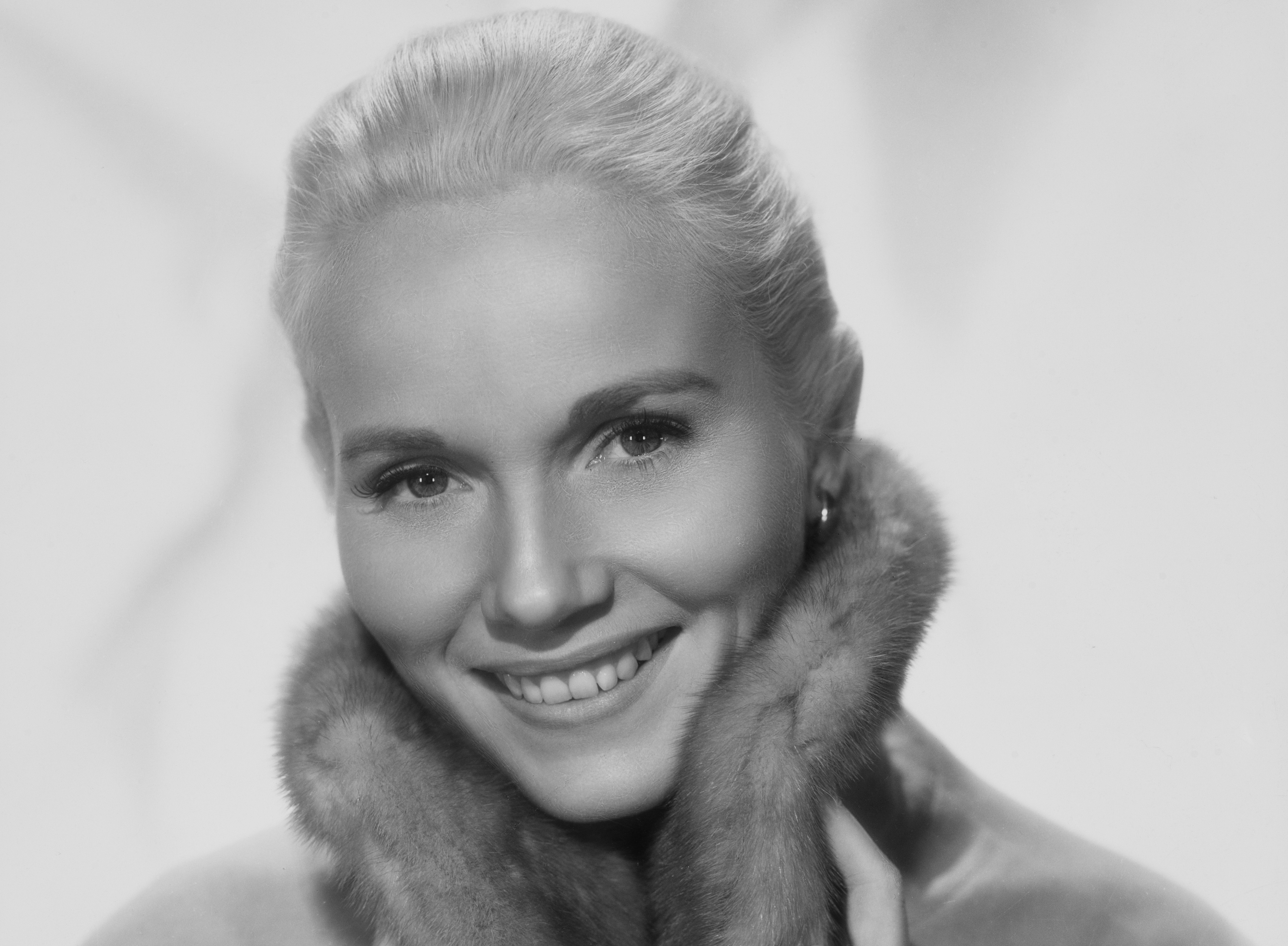American actress Eva Marie Saint modeling a coat