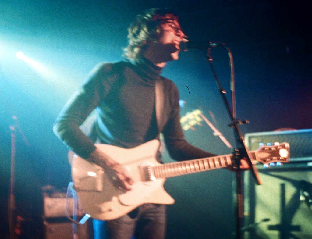 Portrait Photo of Daniel Romano playing a Frank Brothers guitar