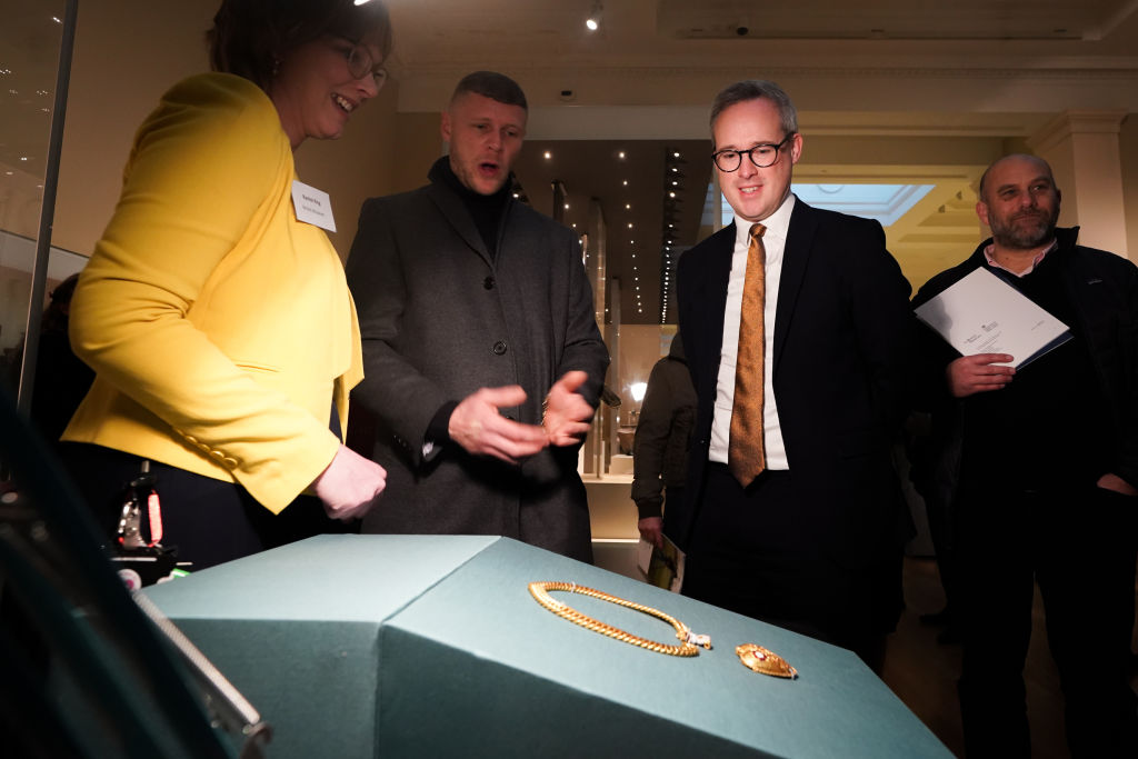 The finder of the chain and pendant associated with Henry VIII and Katherine of Aragon, Charlie Clarke (centre)