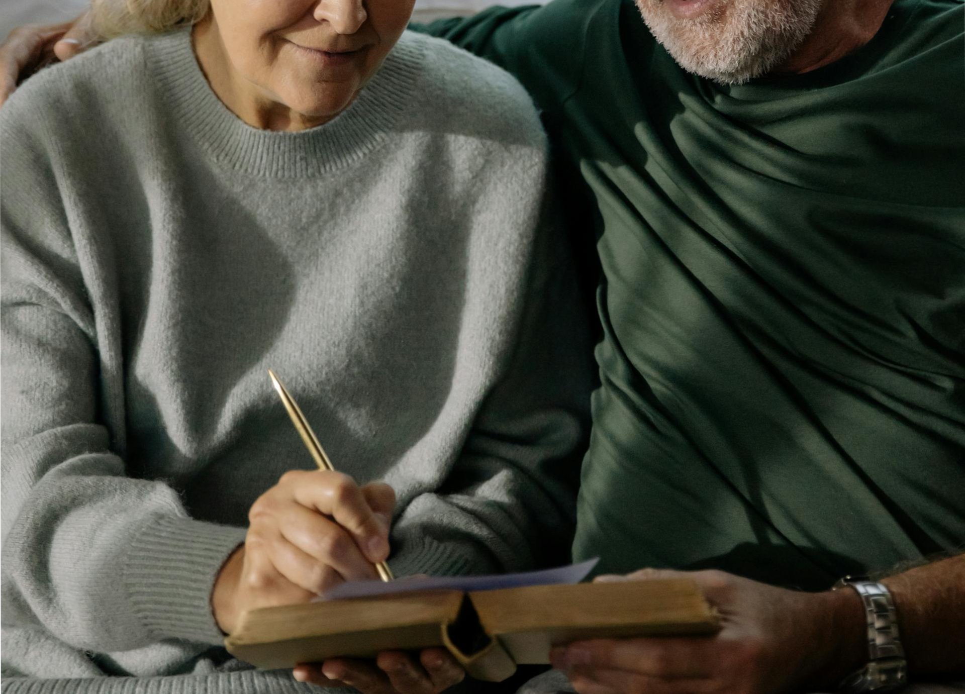 A Woman in Gray Sweater Holding a Pen
