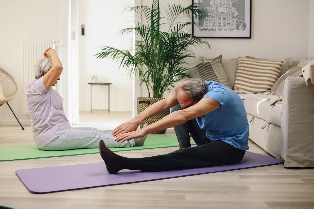 An Elderly Couple Practicing Yoga