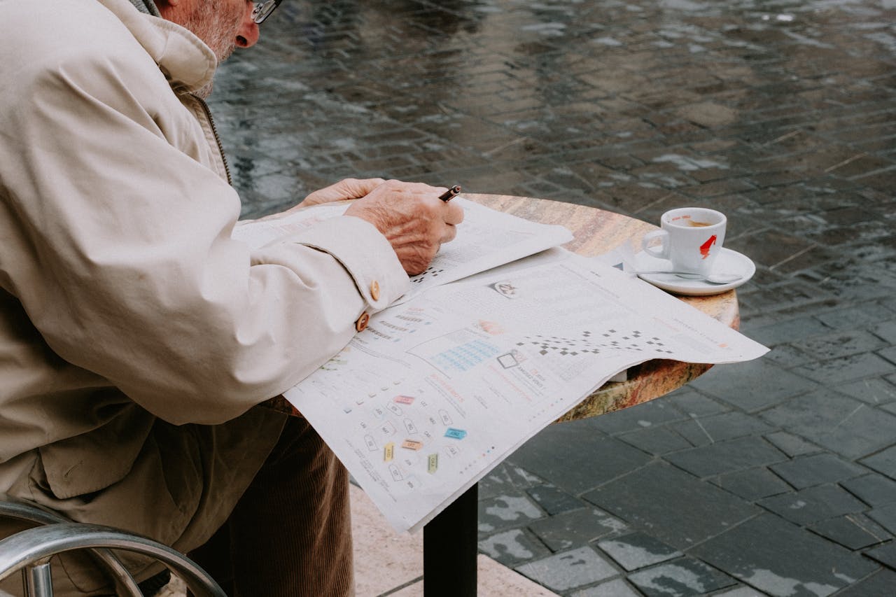 Senior Man Solving a Newspaper Crossword