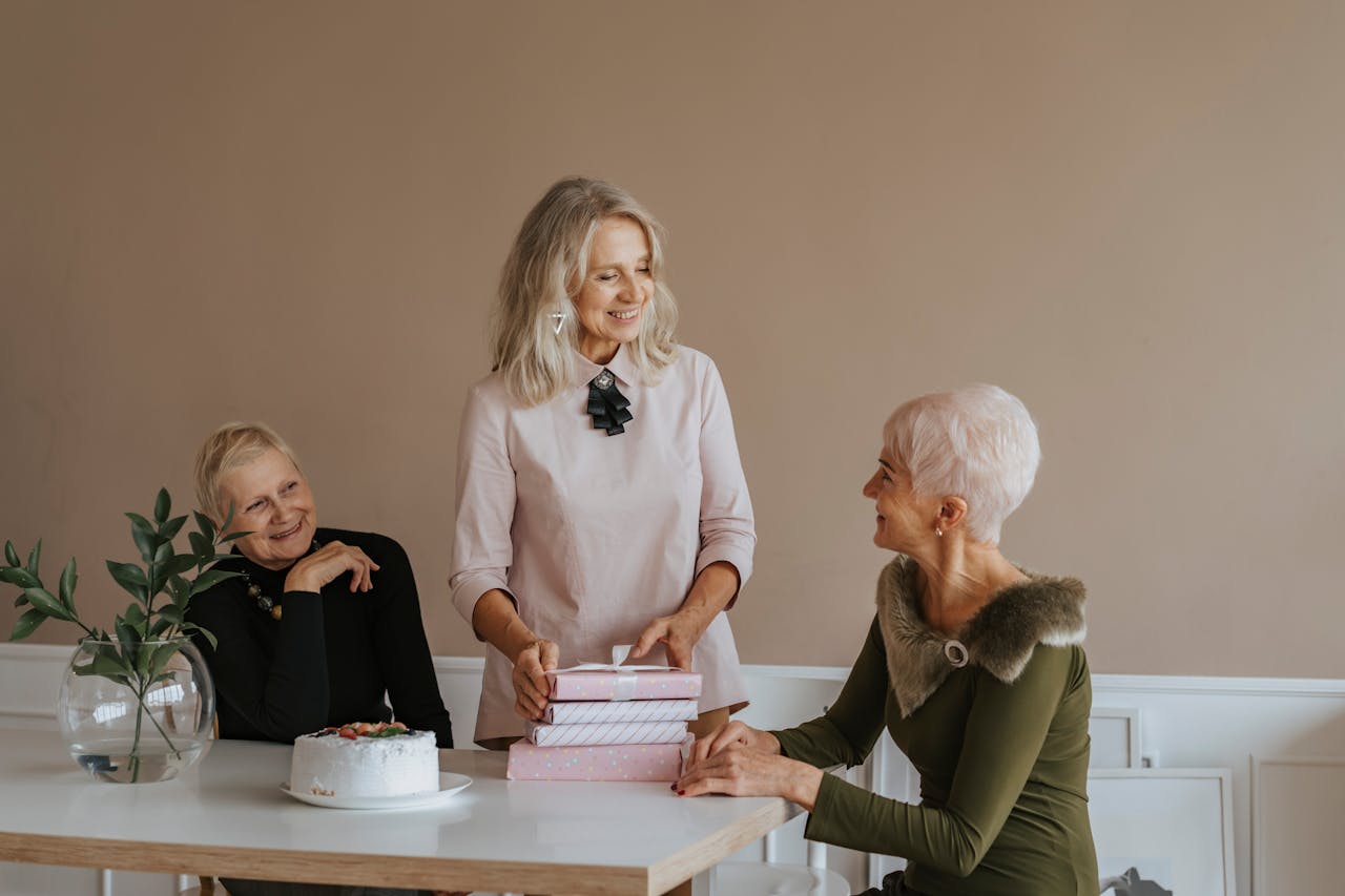 Photo of Elderly Women Talking Near Gifts