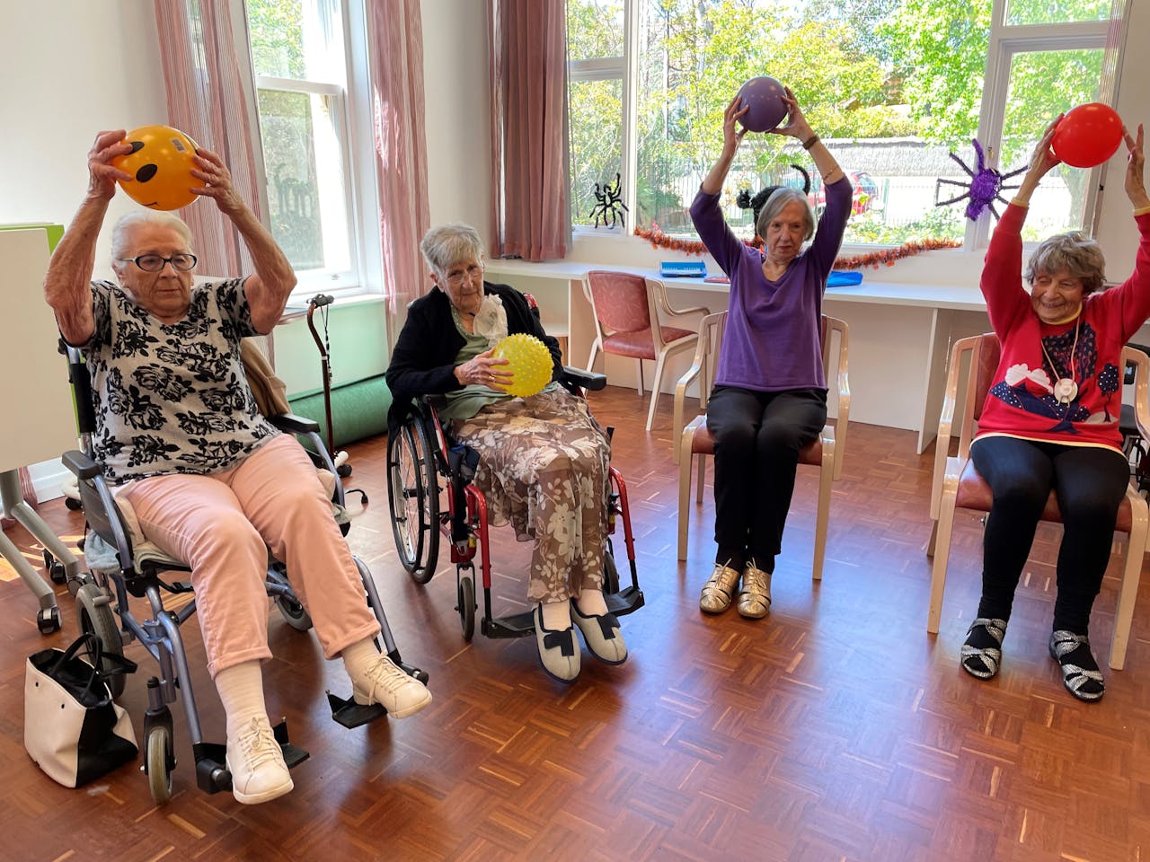 Senior women sitting on a chairs and wheel chairs