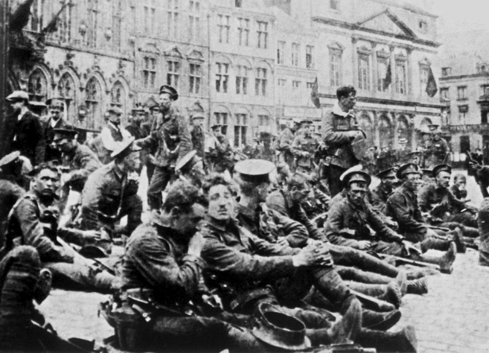 British soldiers from the Royal Fusiliers resting in the town square at Mons