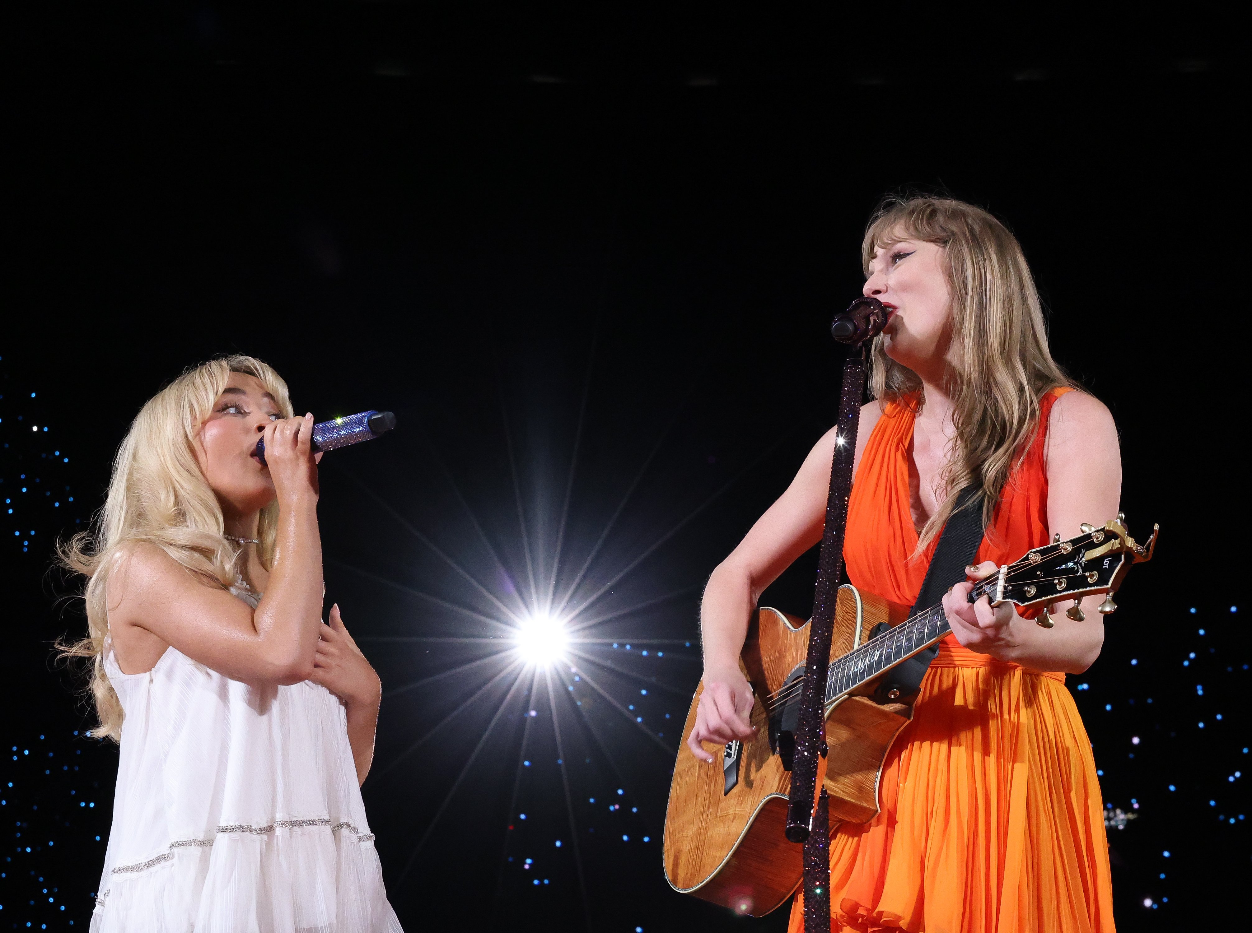 Taylor Swift (R) and Sabrina Carpenter perform at Caesars Superdome