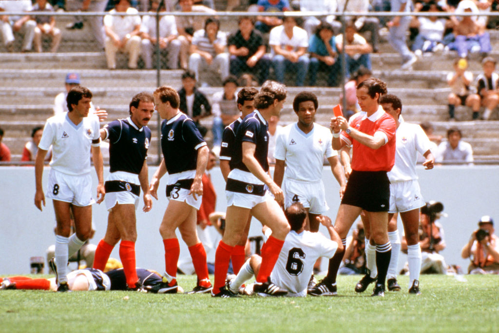 Referee Joel Quiniou shows the red card to Uruguay's Jose Batista