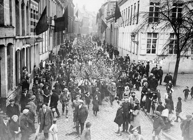 Photograph of Canadian troops marching through the streets of Mons