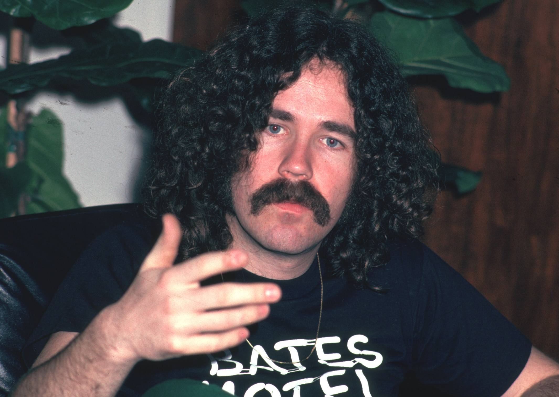 Brad Delp in black t-shirt speaking