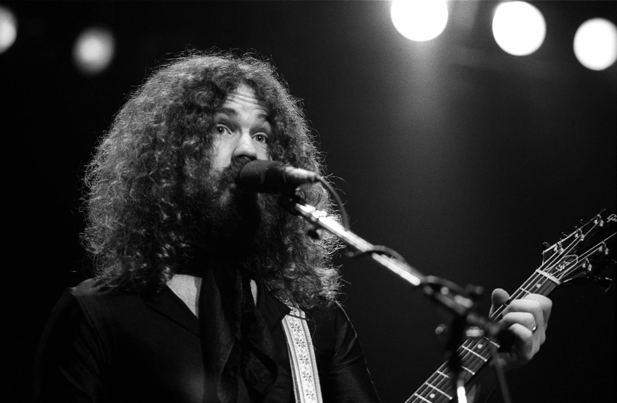 Brad Delp in black outfit performing at Boston Garden