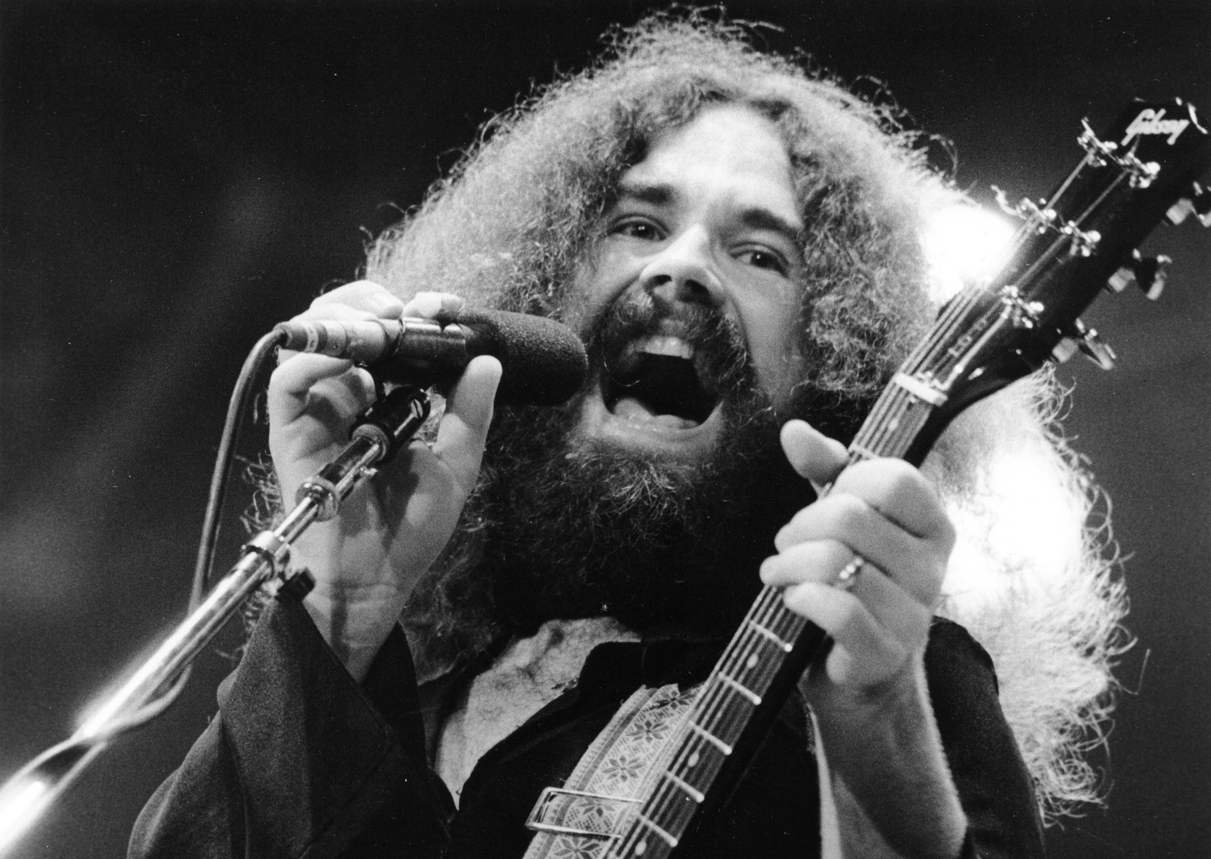 Brad Delp performing on stage