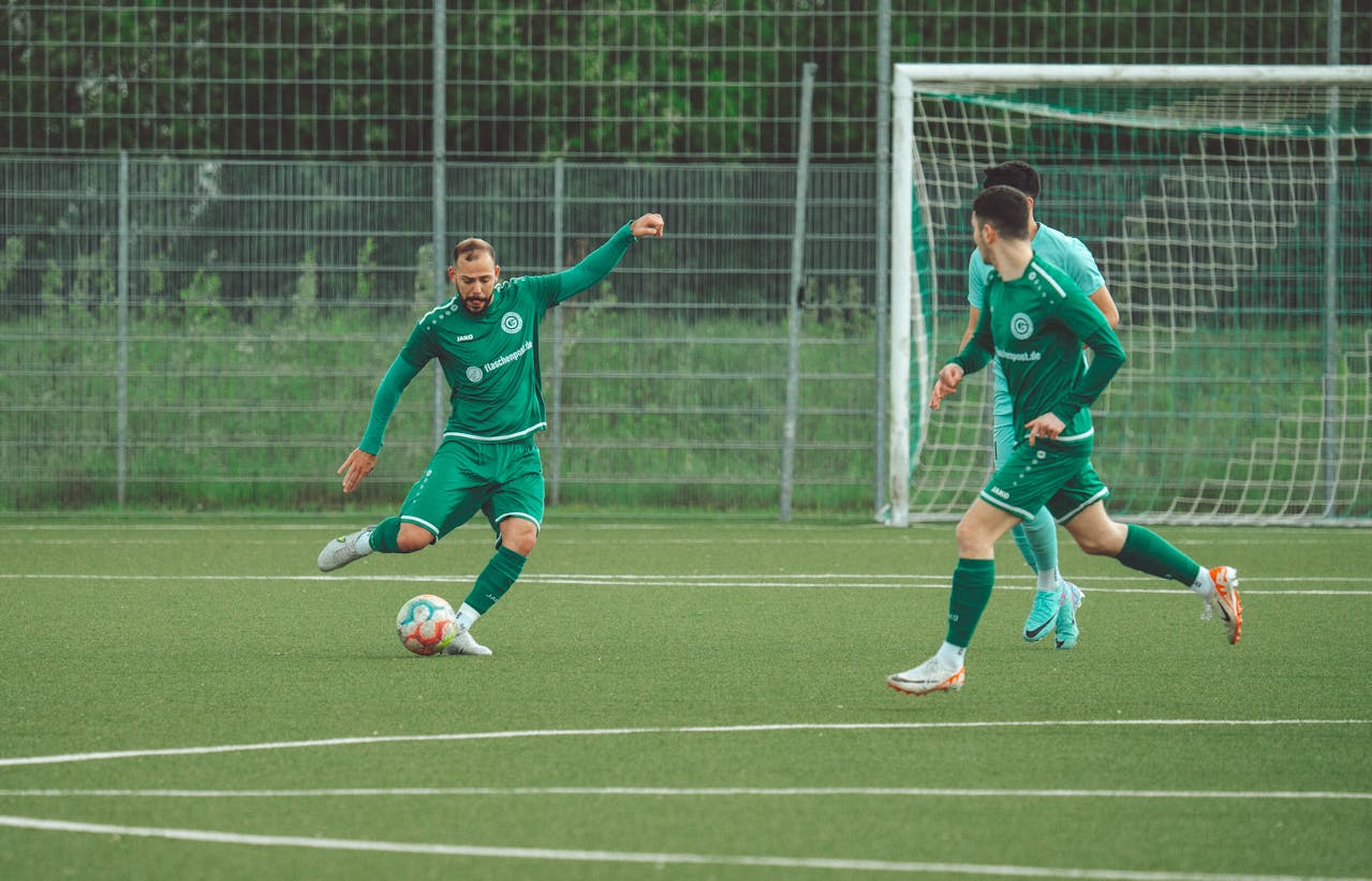 Three men in green soccer jersey