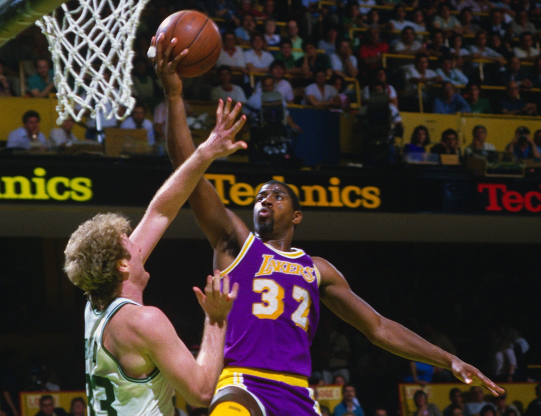 1985: Earvin Magic Johnson #32 of the Los Angeles Lakers goes up to shoot over Larry Bird #33 of the Boston Celtics