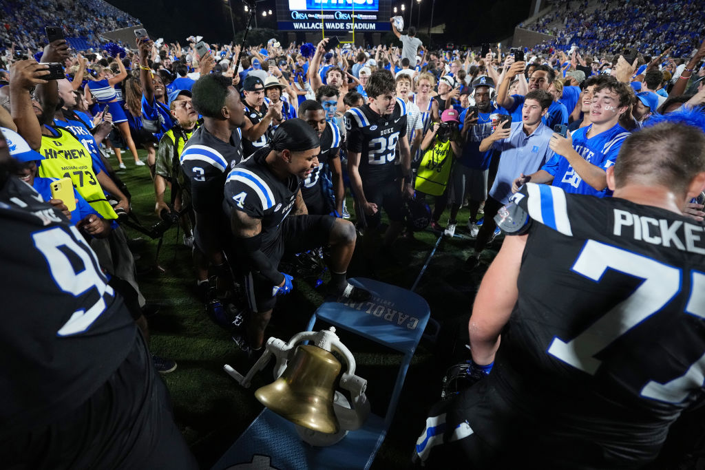 Duke Blue Devils fans storm the field after a win North Carolina Tar Heels