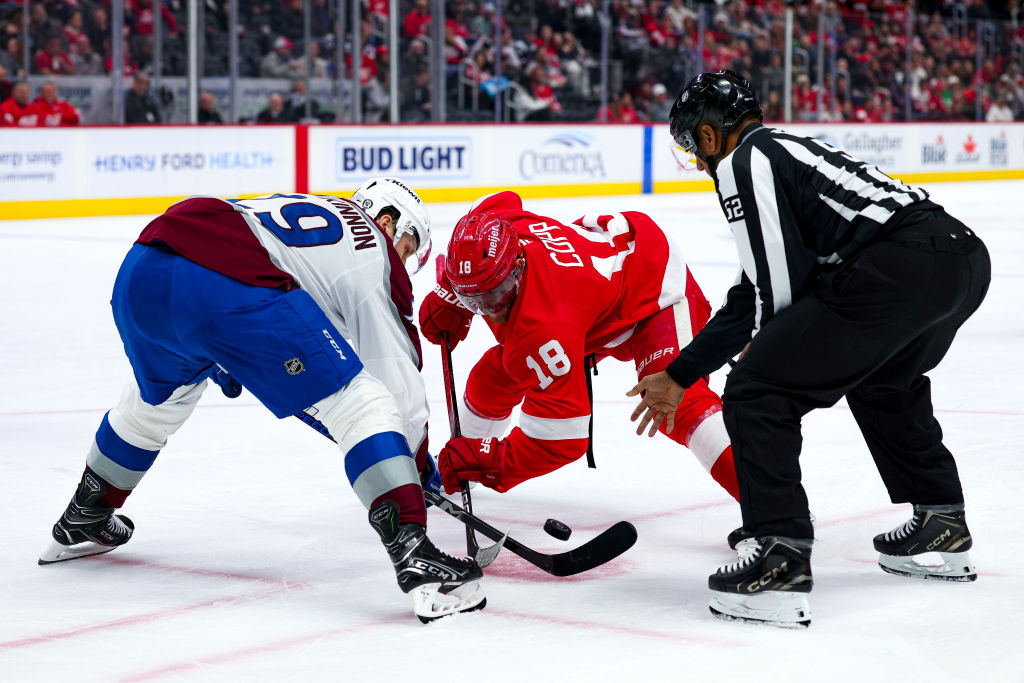 Nathan MacKinnon #29 of the Colorado Avalanche and Andrew Copp #18 of the Detroit Red Wings face off during the second period