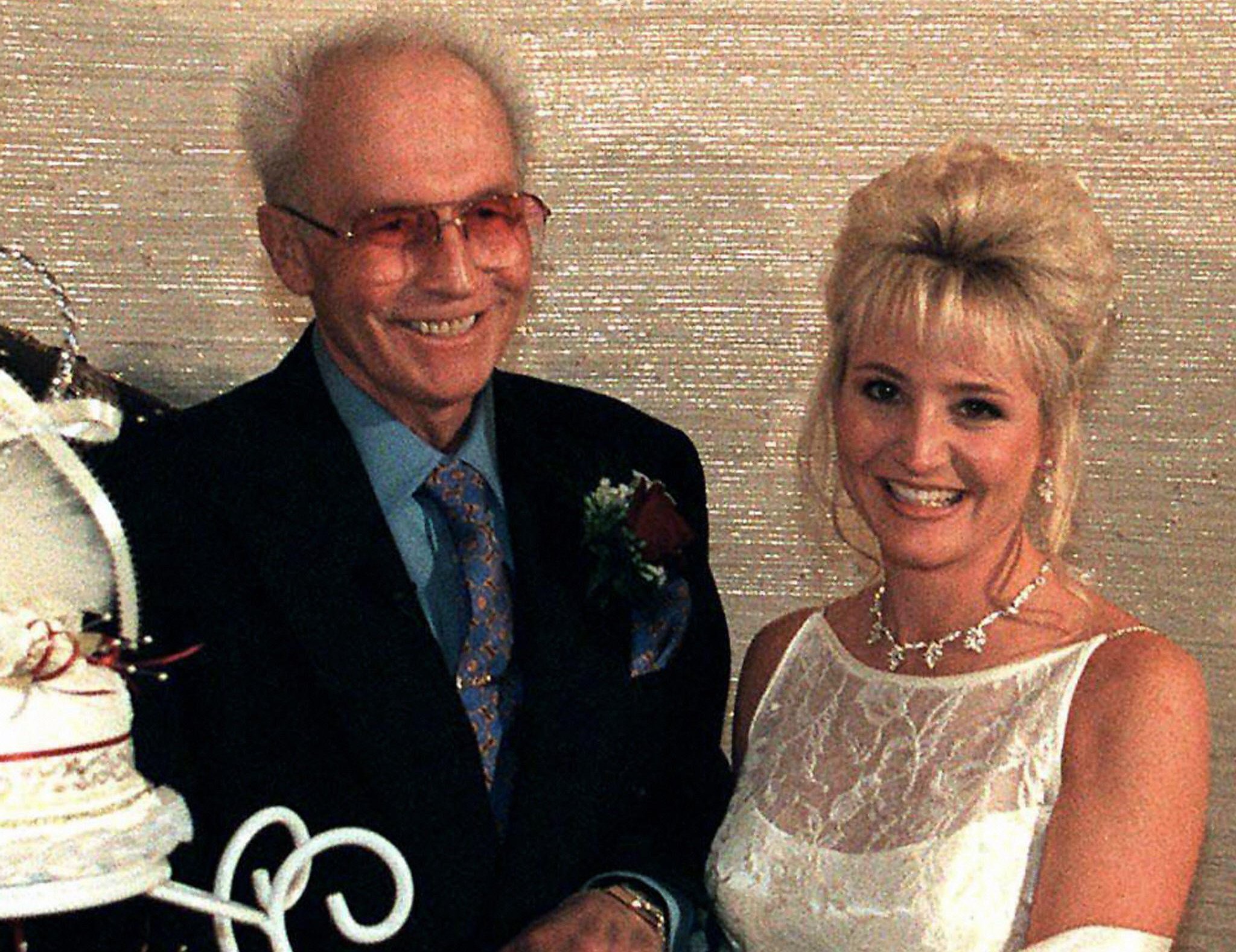 US daredevil Evel Knievel, 61, cuts the wedding cake with his thirty-year-old bride Crystal Kennedy