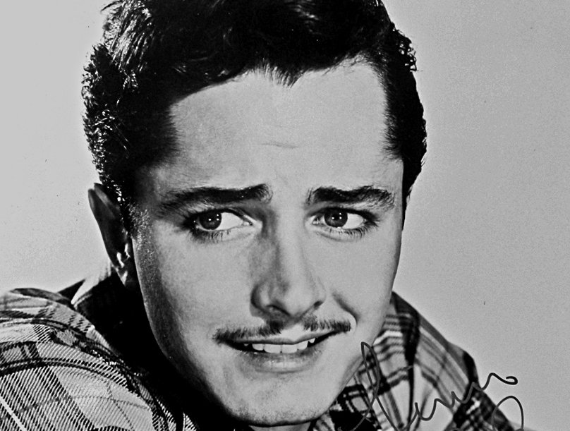 Publicity photo of John Derek in a shirt