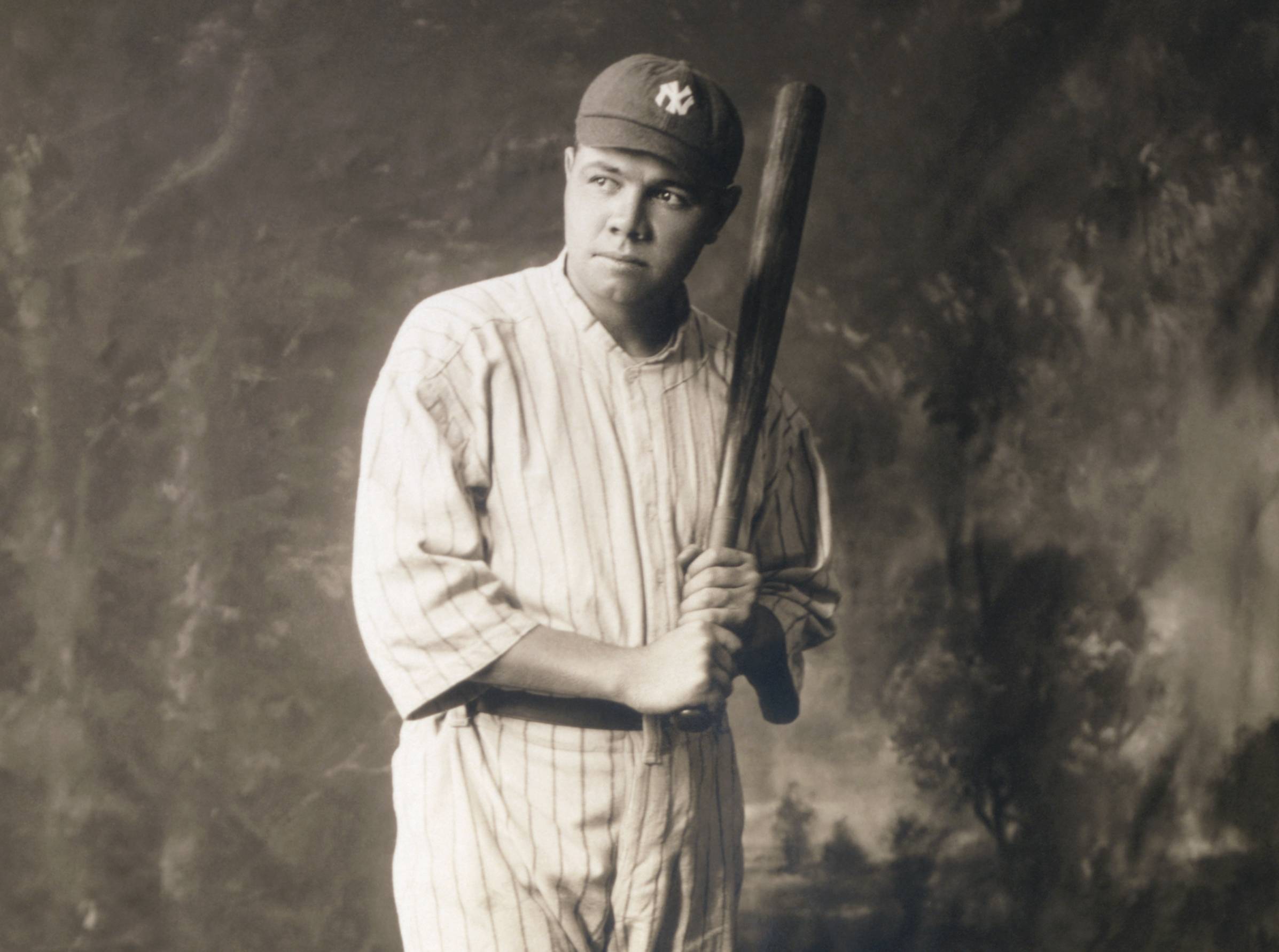 Babe Ruth in baseball uniform, holding baseball bat