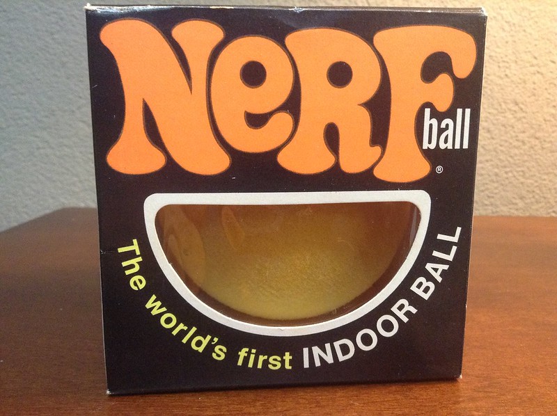 A vintage Nerf ball is showcased in its original packaging.