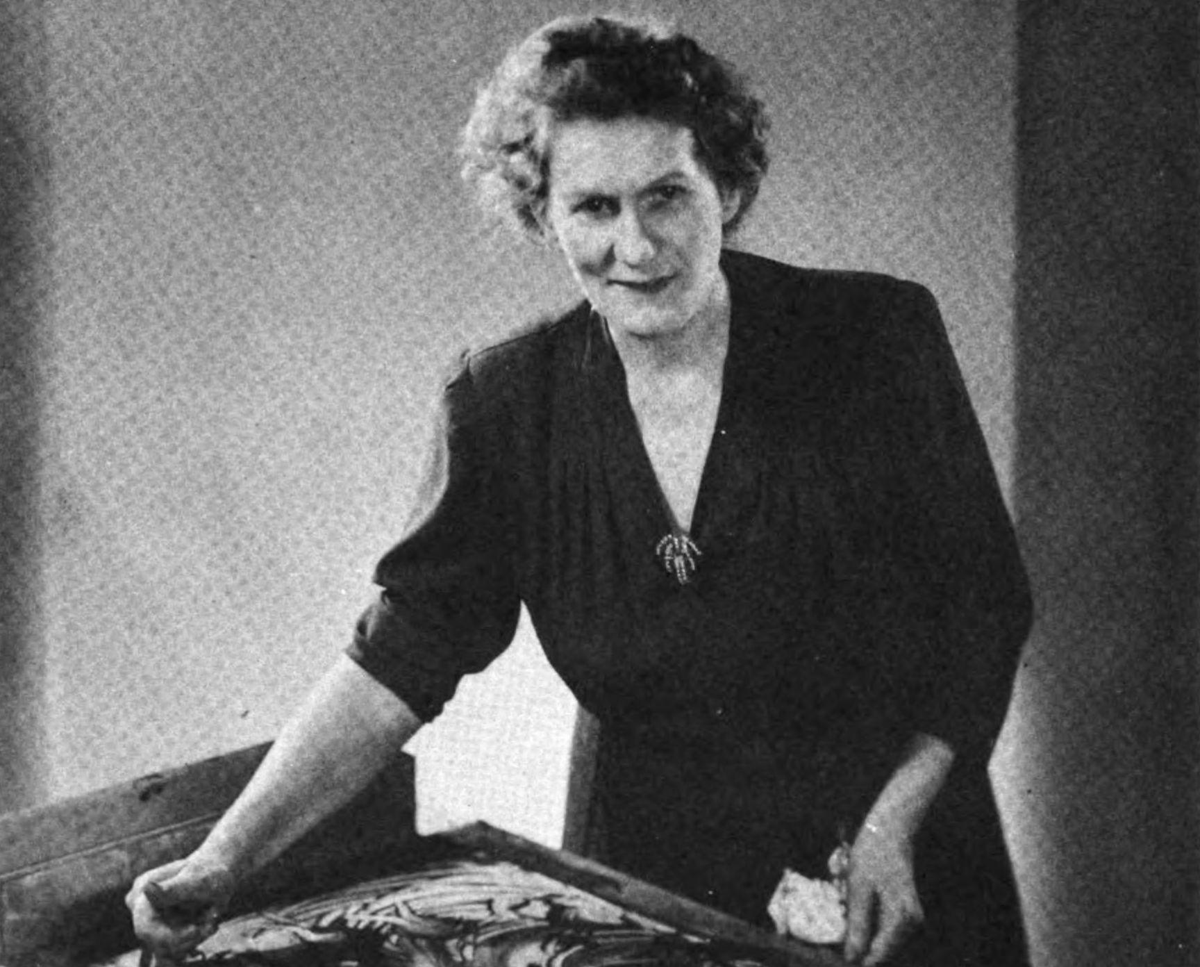 Grayscale Portrait Photo of Ruth Faison Shaw standing by a finger painting