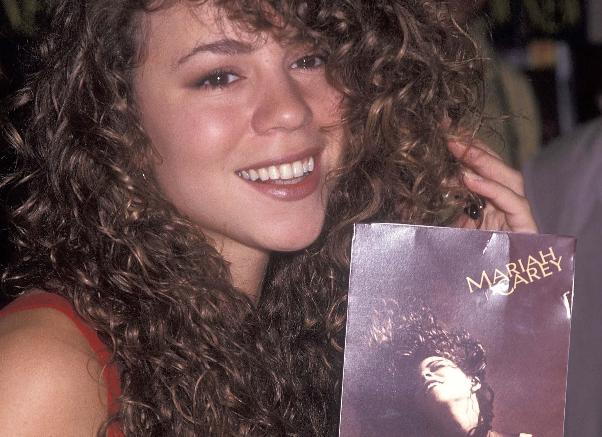 Singer Mariah Carey autographs copies of her new album 