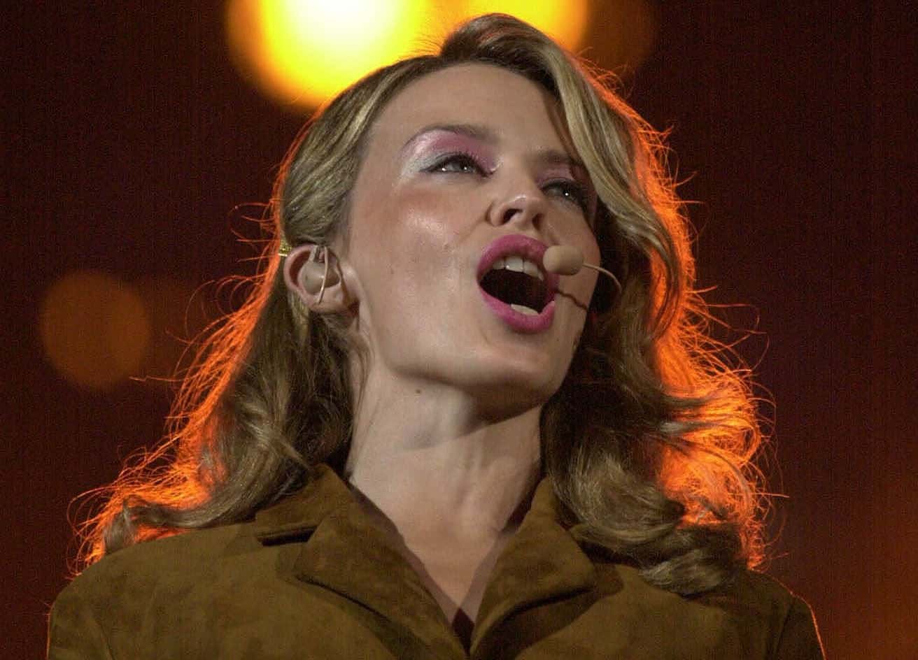 Australian singer Kylie Minogue performing infront of the Paralympic Flame