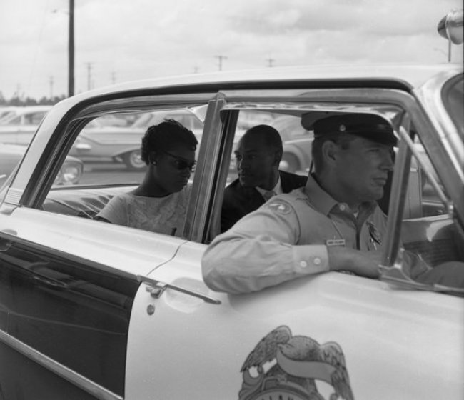 Arrested people riding a police car