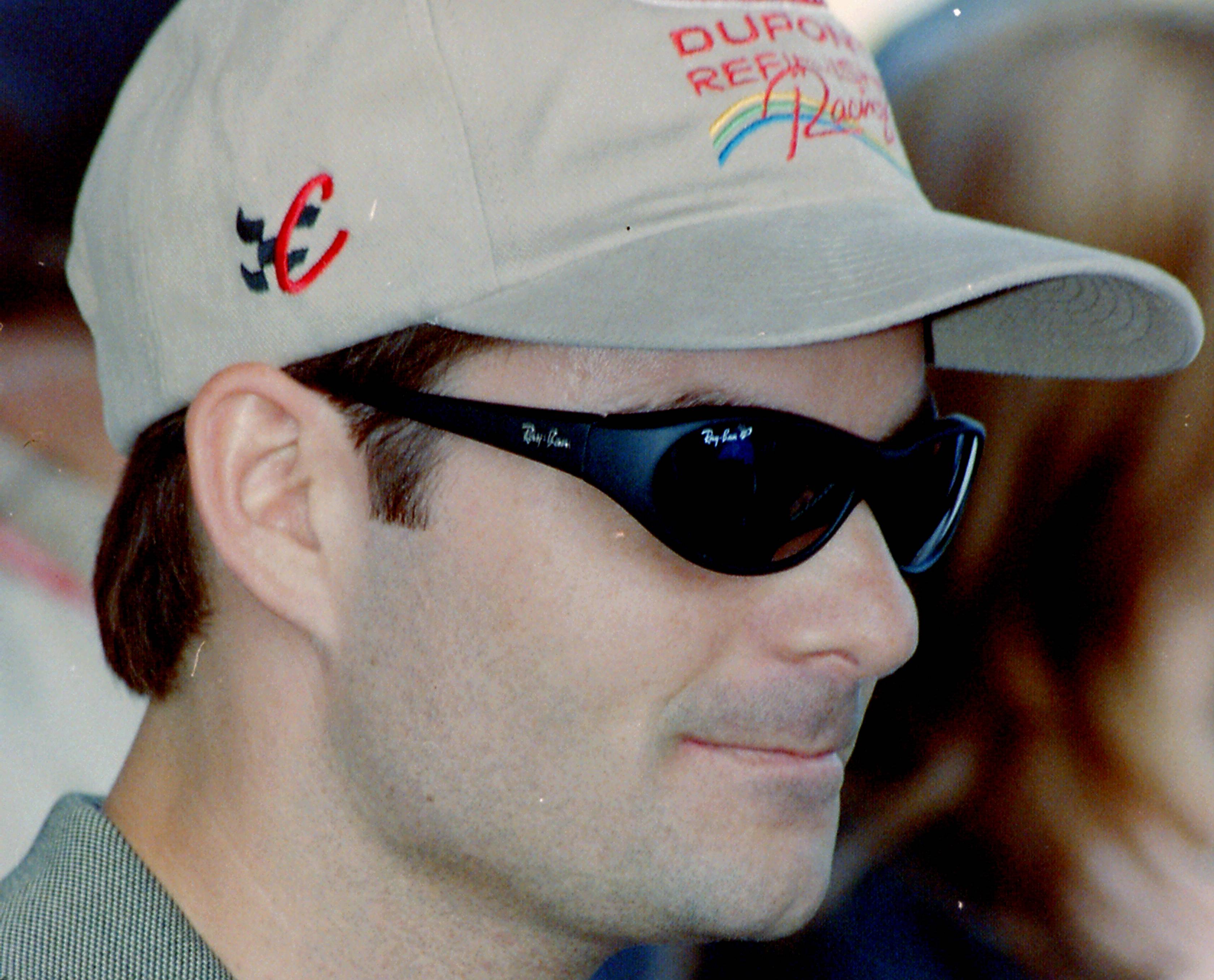 Jeff Gordon wearing a hat and sunglasses