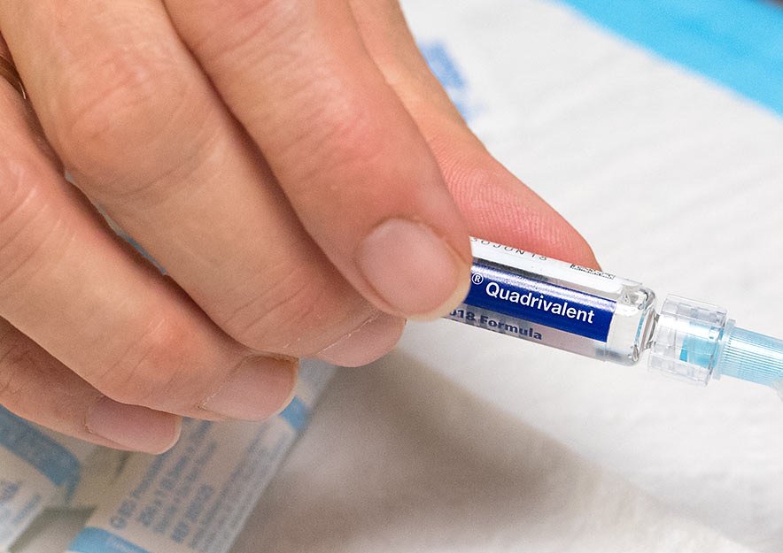 Person holding a flu vaccine
