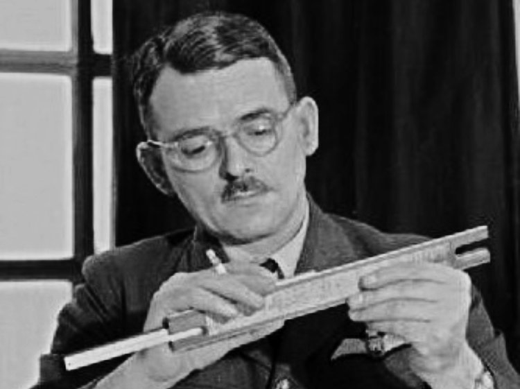 Frank Whittle in a uniform adjusting a slide rule