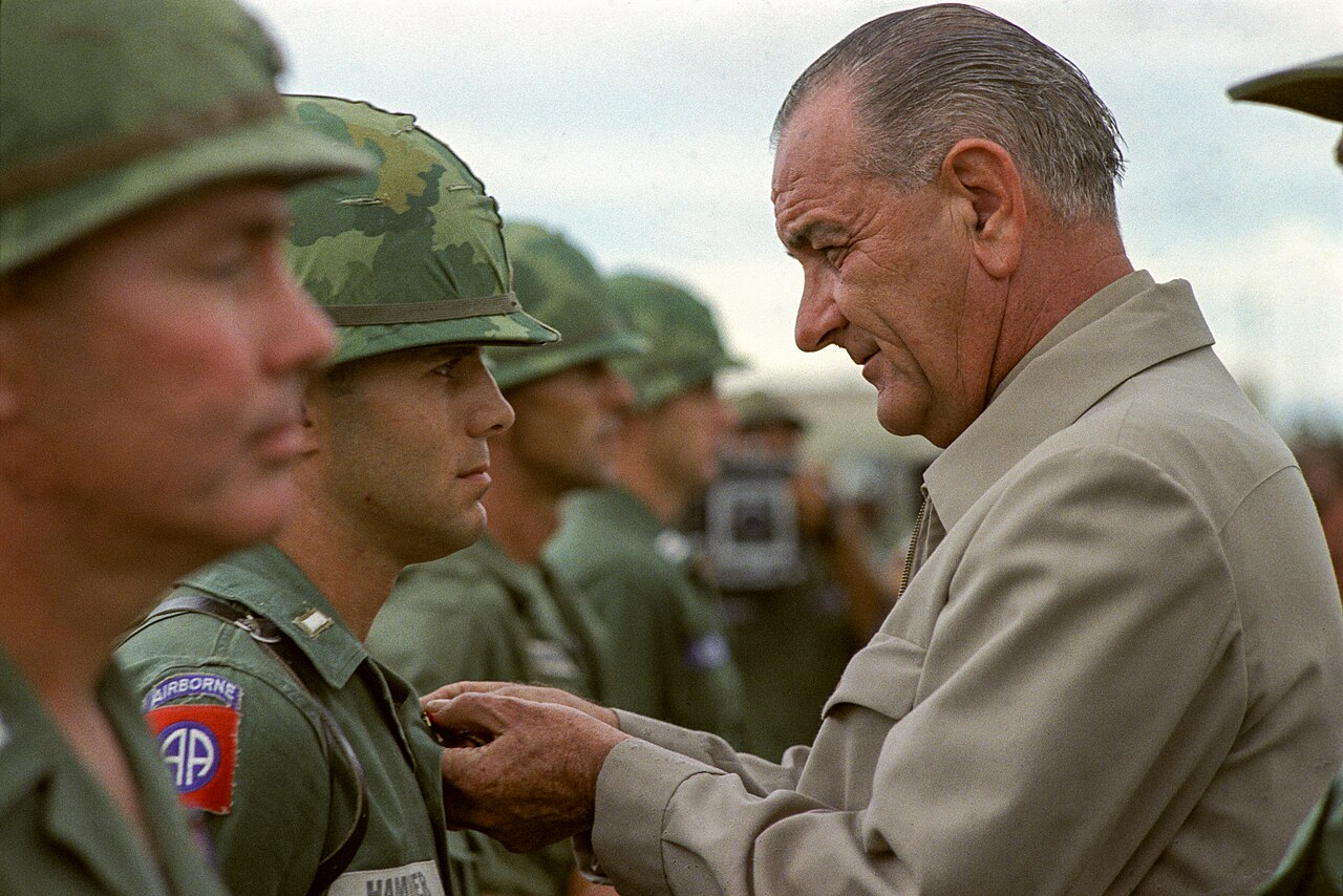 President Lyndon B. Johnson awards the Distinguished Service Cross to First Lieutenant Marty A. Hammer, in Vietnam.