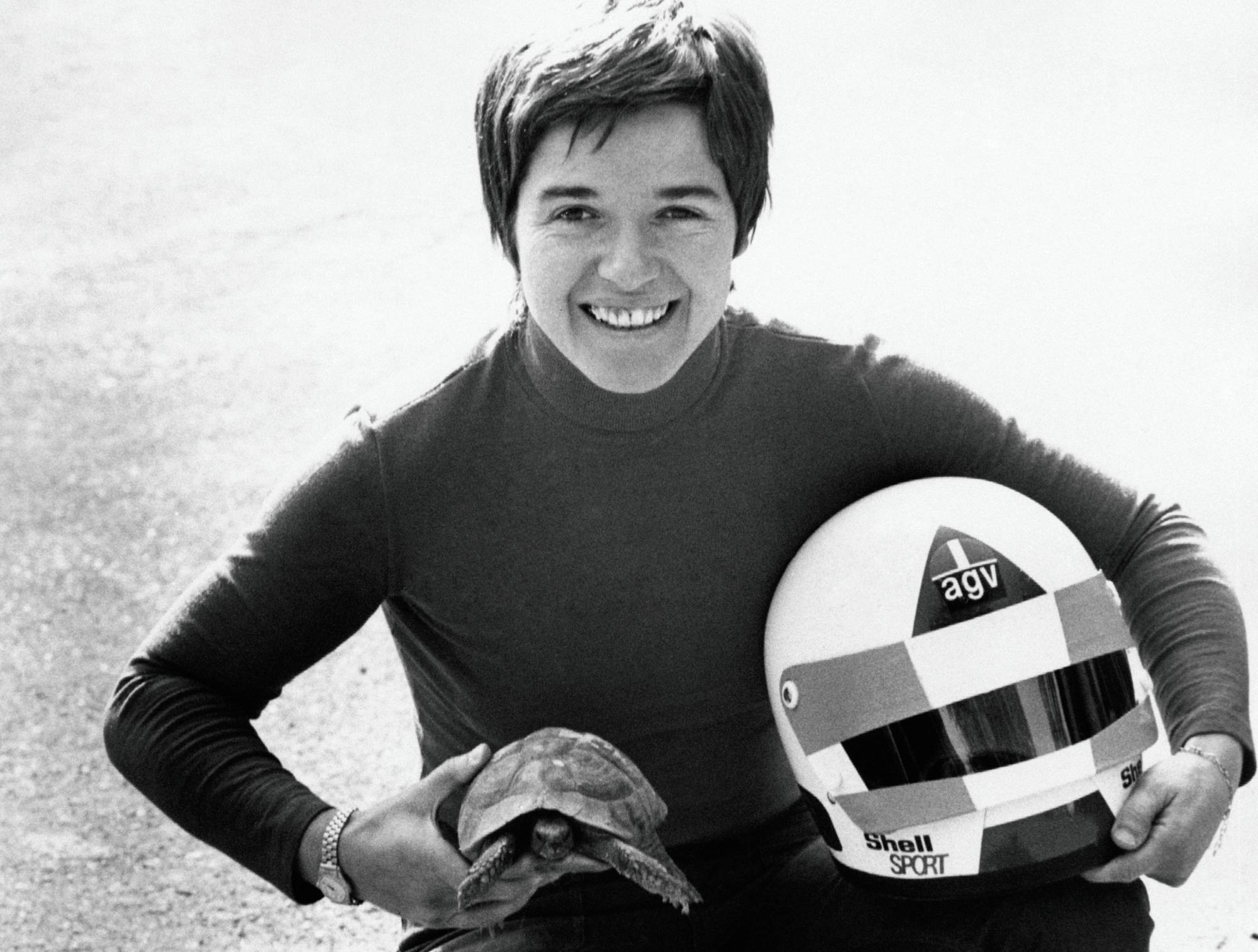 Lella Lombardi (Maria Grazia Lombardi) smiling with a helmet