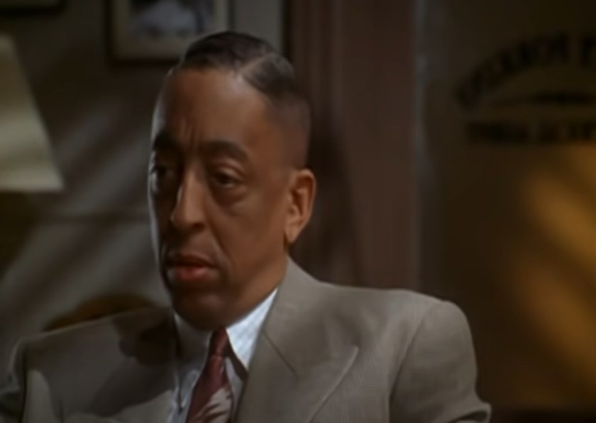 Gregory Hines as Bill Robinson in gray suit 