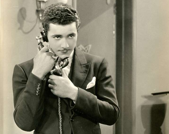 Grayscale Photo of the actor Don Alvarado speaking on a phone