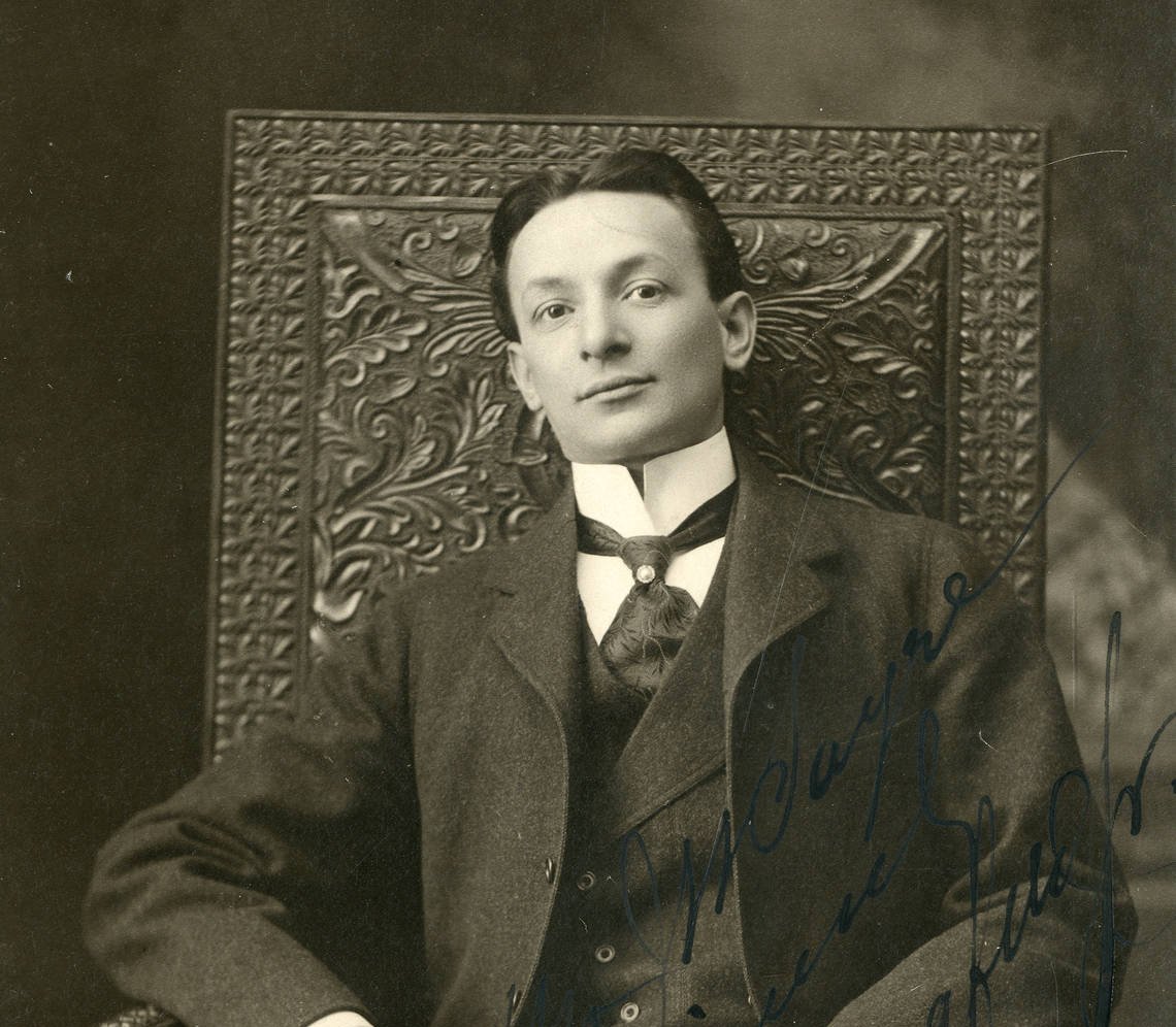 Grayscale Portrait Photo of producer Florenz Ziegfield sitting on a big chair