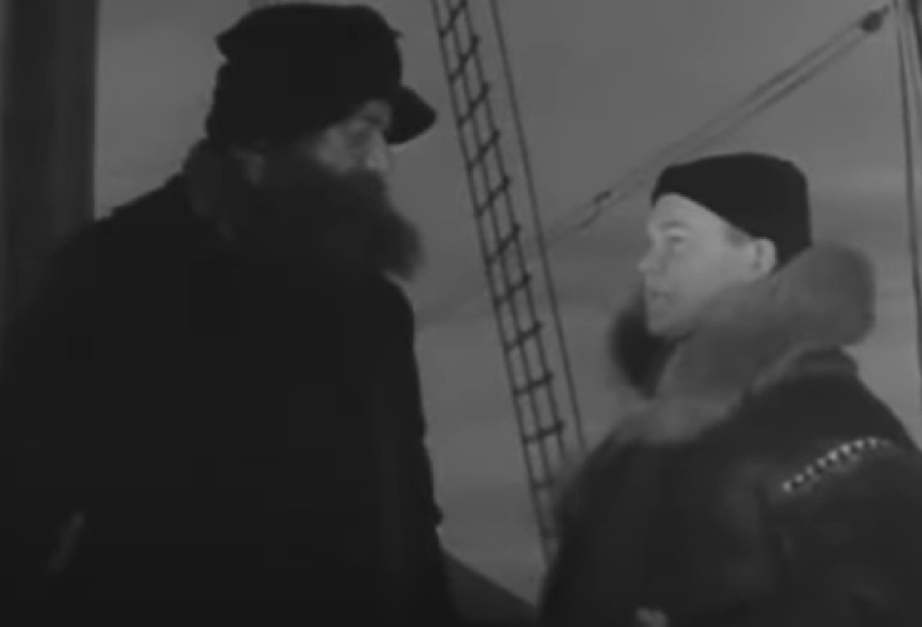 Screenshot of Peter Freuchen talking with other man - from Eskimo (1933)