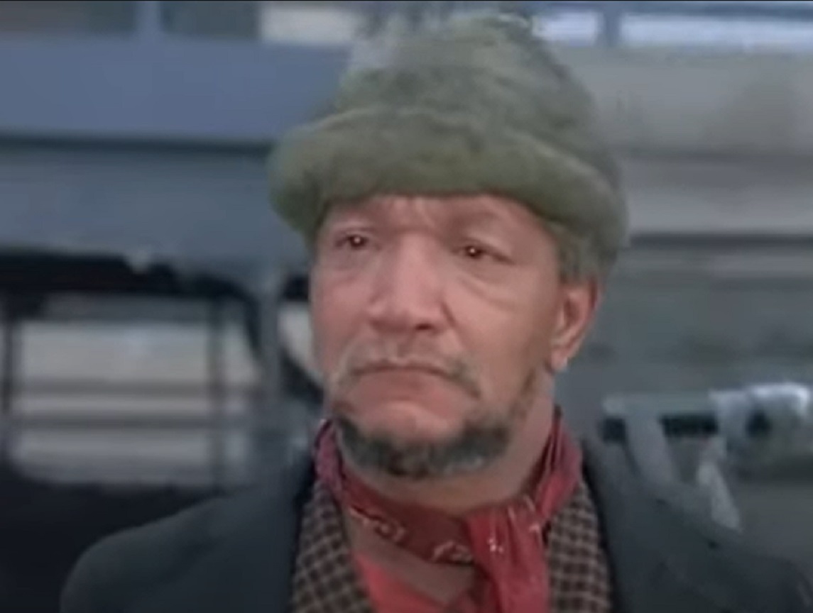 Screenshot of Redd Foxx with green hat outside - from Cotton Comes To Harlem (1970)